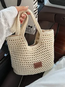 Beige crochet woven shoulder bag with leather patch and satin lining for beach holidays