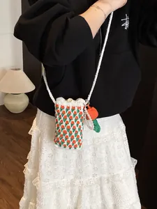 Handmade crochet tulip crossbody bag with wooden button and pearl carrot charm