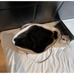 Top view of striped woven tote bag showing spacious interior with zipper pocket and black lining