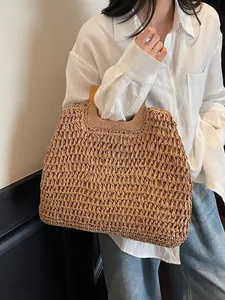 Handcrafted woven straw beach bag with round wooden handles for summer vacation and casual style