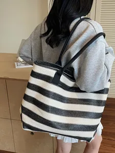 Minimalist black and white striped woven tote bag with long canvas shoulder straps
