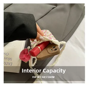 Detail showing internal capacity of the hand-woven tulip crochet bag with phone and lipstick