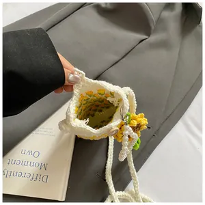 Detailed macro view of handmade crochet tulip bag showing wood button and pearl charms