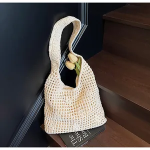 Détail d'un sac cabas en maille crocheté ajouré blanc cassé avec texture rustique