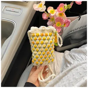 Detailed knit texture of tulip crochet bag with handmade wooden button and pearl handle