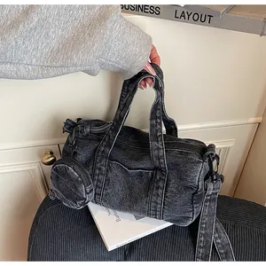 Dettaglio borsa a secchiello in denim lavato nero con portamonete tondo e manici