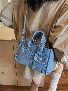 Vintage washed denim crossbody bag with belt buckle handle and silver hardware