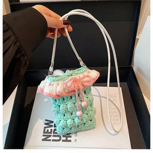 Detailed knit pattern of a mint green crochet bag with pink bow and pearl accents