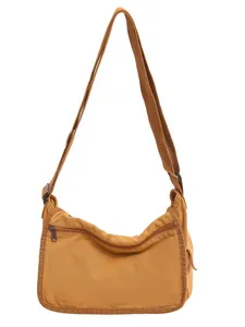 Large brown washed canvas messenger bag with adjustable shoulder strap and zip pocket