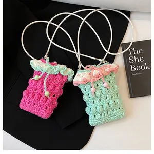 Detail of crochet phone bags in rose red and mint green with 3D knit texture