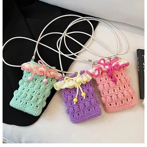 Macro view of handmade crochet mini bags featuring 3D popcorn stitch and ruffle trim