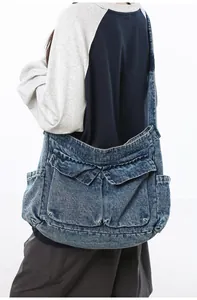 Detail shot of vintage washed denim tote bag featuring large pockets and sturdy strap