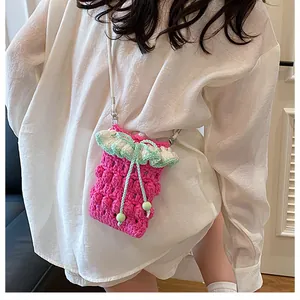 Detailed back view of a pink crochet crossbody phone bag with floral lace edging