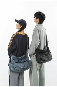 Detail view of large washed denim tote bags with multi-pockets and vintage workwear style