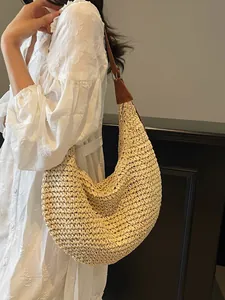 Large woven straw hobo bag with brown leather straps for beach holidays and vacations