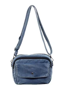 Minimalist blue denim crossbody bag with adjustable strap and front metal snap pocket