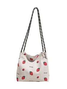 Off-white waffle texture tote bag with red strawberry print and woven rope straps