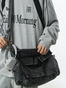 Large vintage washed denim messenger bag with multi-pocket flap and wide shoulder strap