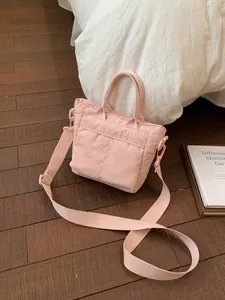 Pink nylon casual handbag with top handle and adjustable wide strap for women