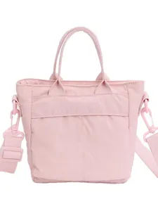 Pink canvas bucket bag with adjustable shoulder strap and top handle for casual commute
