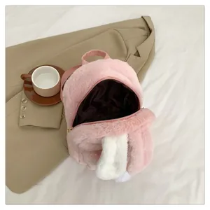 Detailed view of plush pink bunny backpack with soft faux fur ears and brown inner lining