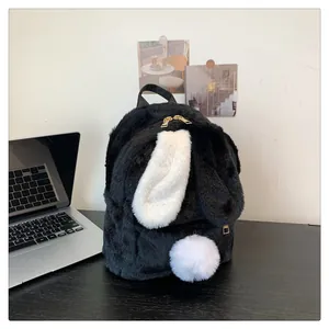 Close-up of black plush bunny backpack featuring white long ears and metal gold zippers