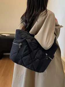 Black quilted tote bag with diamond stitching and silver zipper for stylish commuting