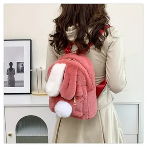 Detailed view of pink plush bunny backpack with cute long ears and soft white tail detail