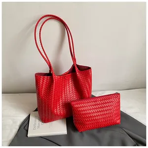 Detail of red woven PU leather tote bag set including a large shopper and matching pouch