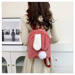 Detailed back view of a pink plush bunny backpack with 3D ears and fuzzy tail