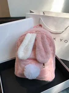 Mini pink plush rabbit backpack with long ears and soft fur in a gift box packaging