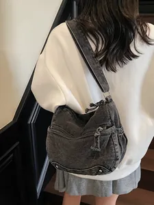 Vintage dark washed denim tote bag with multiple zipper pockets and wide shoulder strap