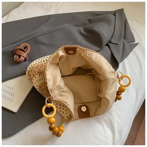 Detail showing the woven tote bag interior with magnetic closure and wooden bead handle
