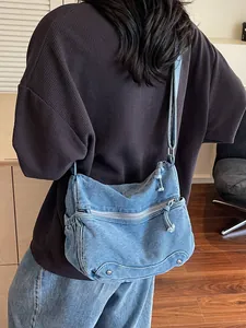 Retro blue denim tote bag with metal rivets shown on model for daily casual commute