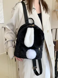 Mini fluffy black backpack with cute bunny ears and white pom-pom for women
