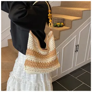 Detail of hollow-out woven tote with wooden bead straps and striped crochet pattern