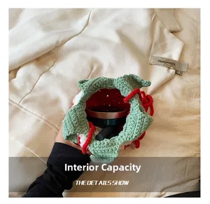 Internal capacity of crochet strawberry bag showing space for lipstick and cushion