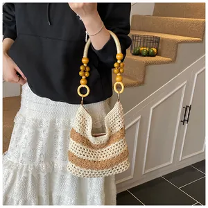 Close-up of woven tote bag featuring striped crochet texture and wooden bead handle