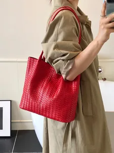 Fashionable red woven leather tote bag for women showing a large capacity and sturdy design