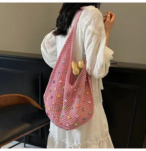 Pink hand-crocheted tote bag with colorful beads and wide shoulder straps detail