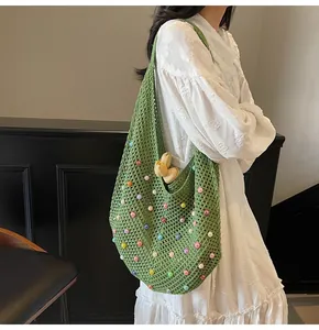 Detailed close-up of a woven green tote bag with colorful beads and tulip decoration