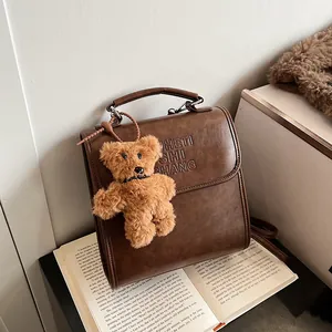 Vintage brown PU leather backpack with letter embossing and cute bear pendant charm