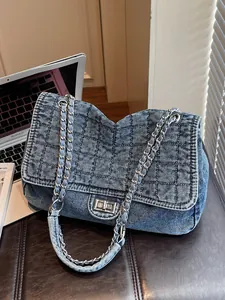 Blue washed denim chain shoulder bag with quilted pattern and silver turn-lock closure