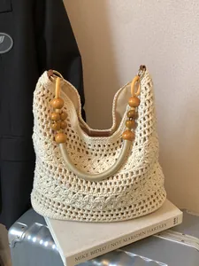 Hollow out woven crochet tote bag with wooden bead handles and gold metal rings