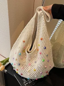Minimalist beige crochet beach tote bag featuring colorful pearls and hollow knit texture