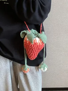 Pink crochet strawberry bag with green leaf detail and crossbody strap for women