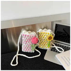 Detail of handmade crochet tulip and sunflower crossbody mini bags with pearl accents