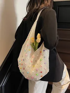 Minimalist crochet beach tote bag with colorful beads shown in a lifestyle shoulder view