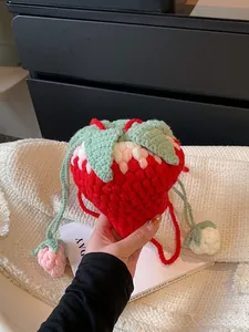 Handmade crochet strawberry crossbody bag with green leaves and drawstring charms