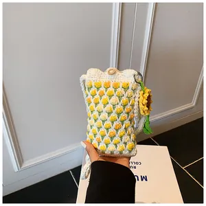 Close-up of tulip crochet phone bag with sunflower charm and pearl decorative detail